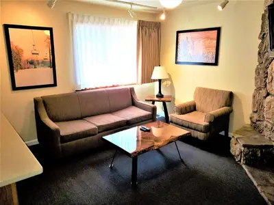 a living room with a couch and a chair at Snow Lake Lodge in Big Bear Lake