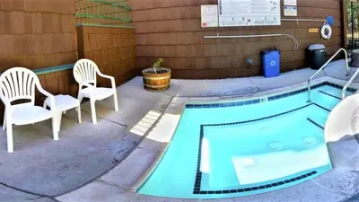 a patio with two chairs and a swimming pool at Snow Lake Lodge in Big Bear Lake