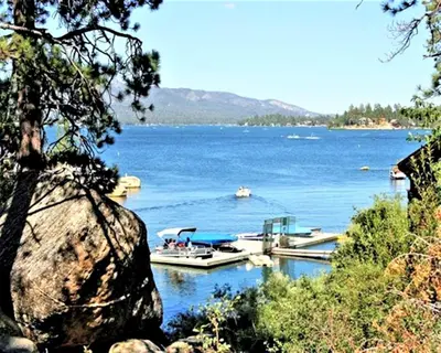 two boats are docked in a large body of water at Snow Lake Lodge in Big Bear Lake