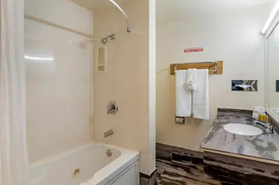 a bathroom with a bath tub and a sink at Anaheim Discovery Inn and Suites in Anaheim