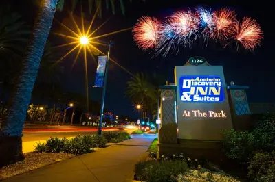a sign in front of a sign with fireworks at Anaheim Discovery Inn and Suites in Anaheim