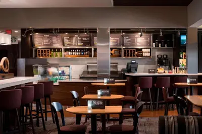 a restaurant with tables and chairs and a bar at Sonesta Select Los Angeles Torrance South Bay in Torrance