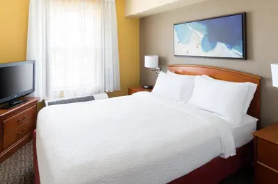 a hotel room with a bed and a television at TownePlace Suites Los Angeles LAX Manhattan Beach in Hawthorne