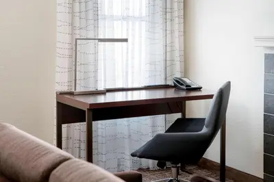 a desk with a phone and a chair in a room at Residence Inn Los Angeles Torrance/Redondo Beach in Torrance