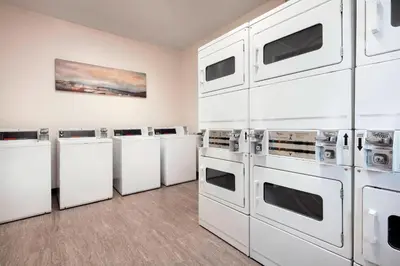 a row of washers and dryers in a room at Residence Inn Los Angeles Torrance/Redondo Beach in Torrance