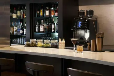 a bar with a counter with drinks on it at Courtyard Los Angeles Torrance/Palos Verdes in Torrance
