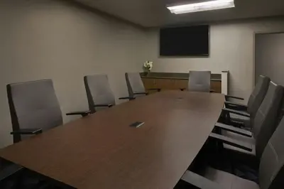 a conference room with a large wooden table and chairs at Courtyard Los Angeles Torrance/Palos Verdes in Torrance