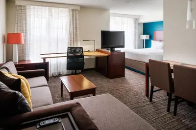 a hotel room with a bed and a living room at Residence Inn by Marriott Cypress Los Alamitos in Los Alamitos