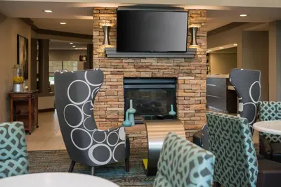 a living room with a fireplace with a flat screen tv at Residence Inn by Marriott Cypress Los Alamitos in Los Alamitos