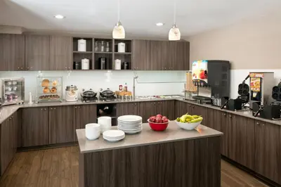 a kitchen with a counter with bowls of fruit on it at Residence Inn Anaheim Placentia/Fullerton in Placentia