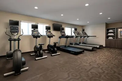 a gym with a row of exercise bikes and treadmills at Residence Inn Anaheim Placentia/Fullerton in Placentia