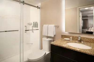 a bathroom with a toilet and a sink and a shower at Residence Inn Pasadena Arcadia in Arcadia