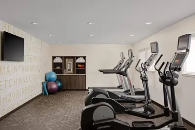 a fitness room with treadmills and exercise bikes at Residence Inn Pasadena Arcadia in Arcadia