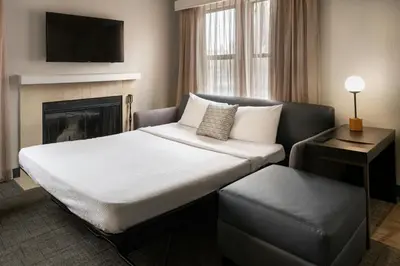 a hotel room with a bed and a fireplace at Residence Inn Pasadena Arcadia in Arcadia