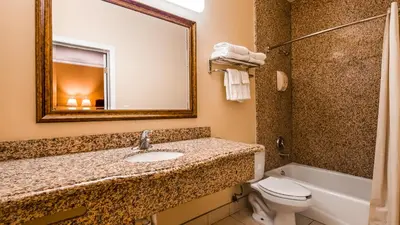 a bathroom with a sink and a toilet and a mirror at Motel 6 South Gate CA in South Gate