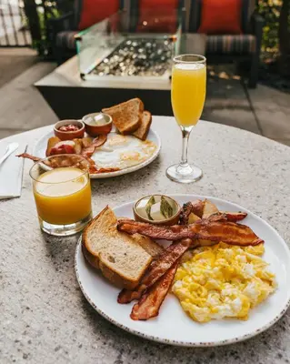 a plate of breakfast food with eggs bacon and toast at Courtyard by Marriott Los Angeles LAX / Century Boulevard in Los Angeles