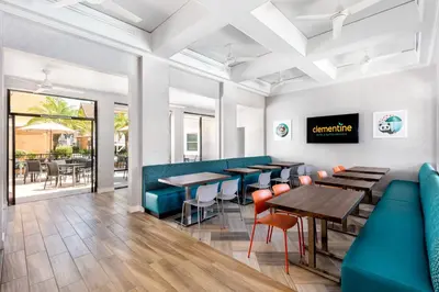 a row of tables and chairs in a restaurant at Clementine Hotel & Suites Anaheim in Anaheim