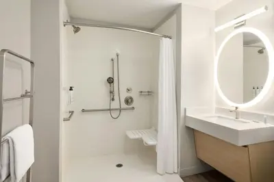 a white bathroom with a sink and a mirror at TownePlace Suites by Marriott Anaheim Maingate Near Angel Stadium in Anaheim