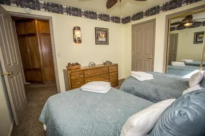 a bedroom with two twin beds and a mirror at Majestic Pines Home in Big Bear Lake