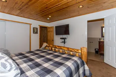 a bedroom with a bed with a checkered blanket at Big Bear Splash Home in Big Bear Lake