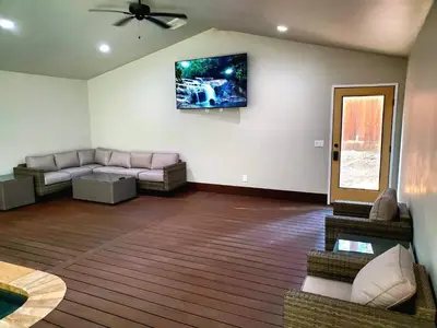 a living room with a couch and a tv on the wall at Big Bear Splash Home in Big Bear Lake