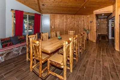 a dining room with a wooden table and chairs at Big Bear Splash Home in Big Bear Lake