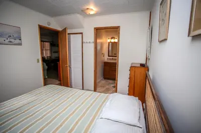 a small bedroom with a bed and a bathroom at Mountain Air Home in Big Bear Lake