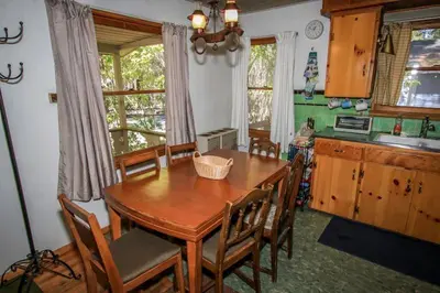 a kitchen with a wooden table and some chairs at Mountain Air Home in Big Bear Lake