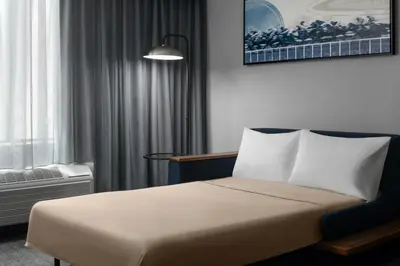 a hotel room with a bed and a window at Courtyard Los Angeles Burbank Airport in Burbank