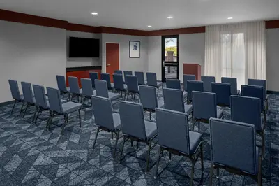 a conference room with chairs and a flat screen tv at Courtyard by Marriott Santa Clarita Valencia in Valencia