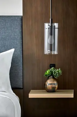 a potted plant sitting on a shelf next to a bed at Anaheim Marriott in Anaheim