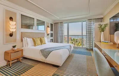 a bedroom with a bed and a large window at Viceroy Santa Monica in Los Angeles