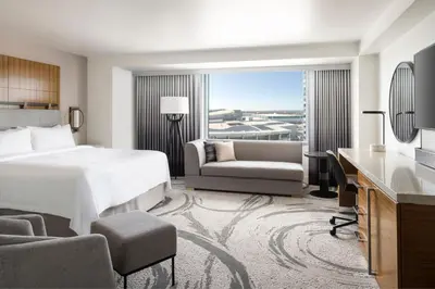 a hotel room with a bed and a desk and chair at JW Marriott Los Angeles L.A. LIVE in Los Angeles