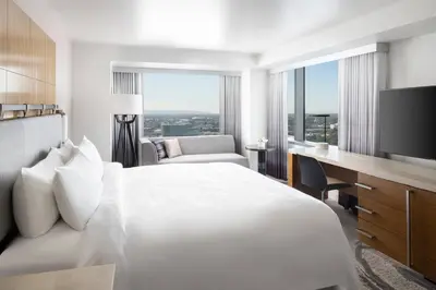 a hotel room with a bed and a desk and a television at JW Marriott Los Angeles L.A. LIVE in Los Angeles