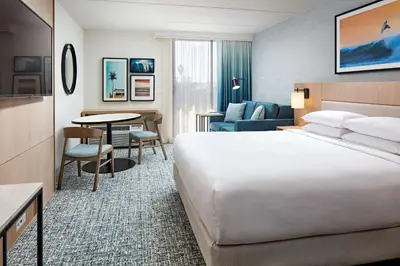 a hotel room with a large bed and a table at Hotel MDR Marina del Rey- a DoubleTree by Hilton in Los Angeles