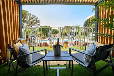 a patio with two chairs and a table and a playground at Hotel MDR Marina del Rey- a DoubleTree by Hilton in Los Angeles