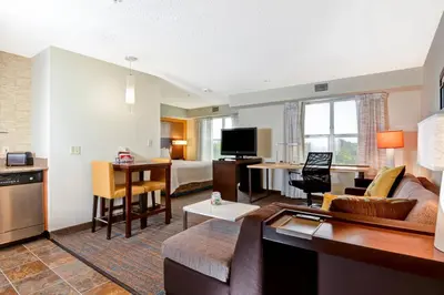 a living room with a couch and a room with a kitchen at Residence Inn Los Angeles LAX/El Segundo in El Segundo