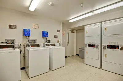 a laundry room with white washers and refrigerators at Residence Inn Los Angeles LAX/El Segundo in El Segundo