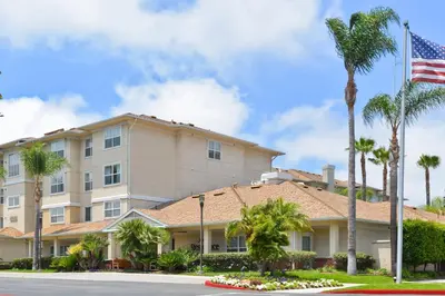 a hotel with palm trees and an american flag at Residence Inn Los Angeles LAX/El Segundo in El Segundo