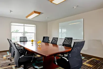 a conference room with a wooden table and black chairs at Residence Inn Los Angeles LAX/El Segundo in El Segundo
