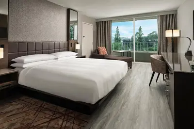a hotel room with a large bed and a large window at Warner Center Marriott Woodland Hills in Woodland Hills