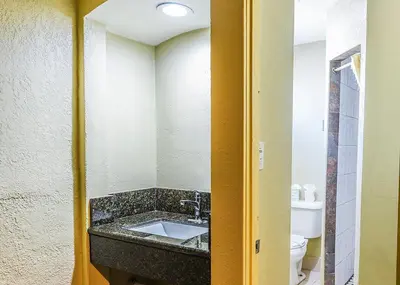 a bathroom with a sink and a toilet at Pacifica Motel in Long Beach