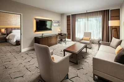 a hotel room with a couch and a bed at Sheraton Los Angeles San Gabriel in San Gabriel