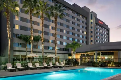 a hotel with a pool and palm trees at Bakersfield Marriott at the Convention Center in Bakersfield