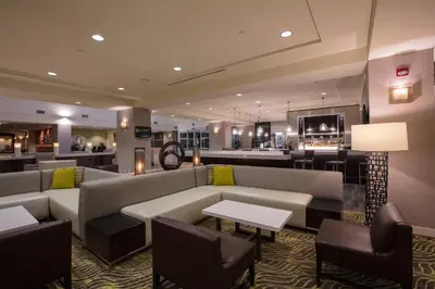 a hotel lobby with couches and a bar at Bakersfield Marriott at the Convention Center in Bakersfield