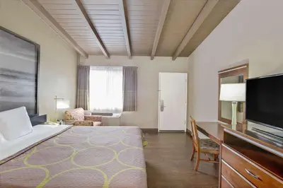 a hotel room with a bed and a flat screen tv at Super 8 by Wyndham Los Angeles-Culver City Area in Los Angeles