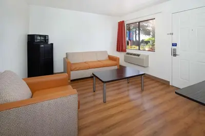 a living room with a couch and a table at Motel 6-Arcadia, CA - Los Angeles - Pasadena Area in Arcadia