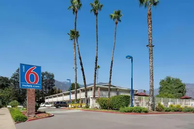 a hotel with palm trees in front of a building at Motel 6-Arcadia, CA - Los Angeles - Pasadena Area in Arcadia