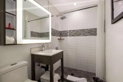 a bathroom with a sink and a shower at Sunset West Hotel, SureStay Collection By Best Western in Los Angeles