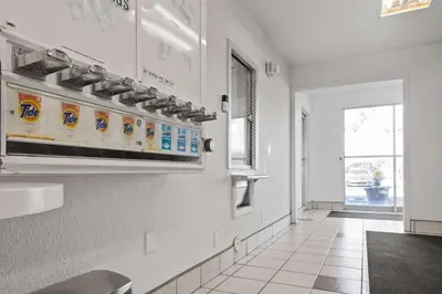 a hallway of a restaurant with a row of bleach signs on the wall at Motel 6-Ventura, CA - Beach in Ventura